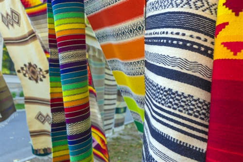 Blankets being aired on a washing line.
