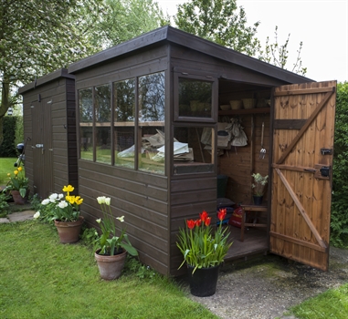 A classy brown shed with windows and a welcoming open door