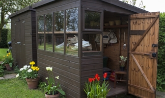 A classy brown shed with windows and a welcoming open door